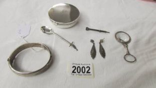 A hall marked silver bangle, a silver spoon, a pair of silver marcasite earrings,