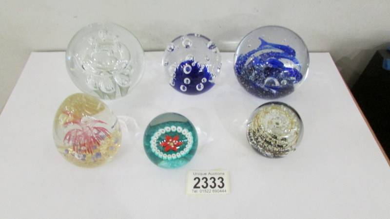 Six glass paperweights including millifiori.