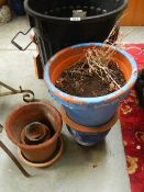 A quantity of small terracotta pots and a bin.