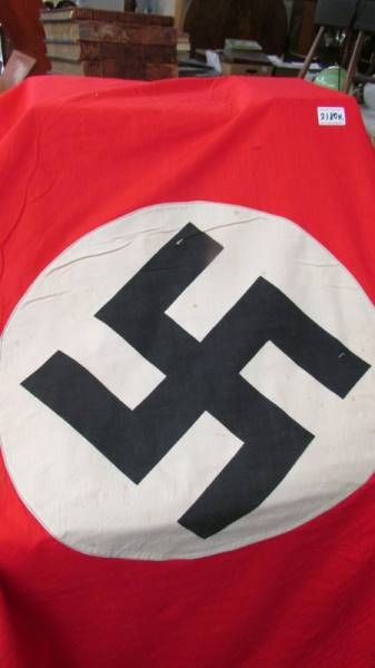 A red Nazi banner with central swastika. - Image 2 of 2