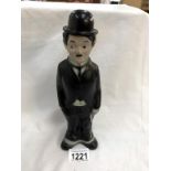 A vintage Charlie Chaplin figure talcum powder holder
