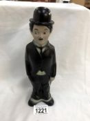 A vintage Charlie Chaplin figure talcum powder holder