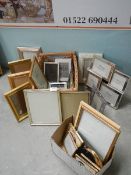 A quantity of new and used picture frames.