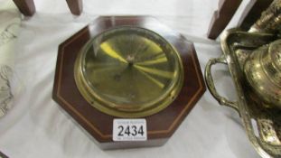 A mahogany inlaid octagonal barometer.