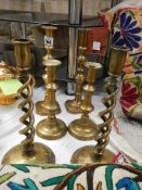 Three pairs of old brass candlesticks.