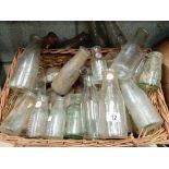 A wicker basket full of various milk bottles