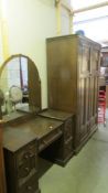 An early 20th century oak dressing table with matching wardrobe.