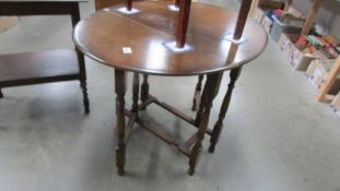 A 1930/50's oak gate leg table, 73 x 34 cm closed, 104 x 73 cm open, 73 cm high.