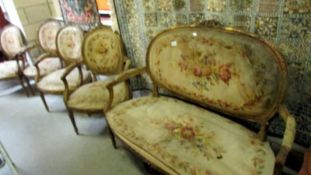 An early 19th century gilt and tapestry suite comprising 2 seat sofa and 4 arm chairs