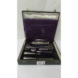 A cased silver plate manicure set (2 items missing and one odd item.