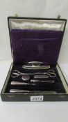 A cased silver plate manicure set (2 items missing and one odd item.