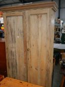 An antique pine 2 door cupboard.