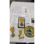 2 American Vietnam service medals together with a miniature service medal and a Zippo Vietnam