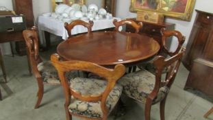 A Victorian oval tip top loo table together with a set of 6 Victorian mahogany dining chairs.