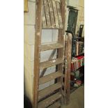 Two vintage wooden step ladders.