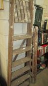 Two vintage wooden step ladders.