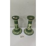 A pair of green Wedgwood Jasper ware candlesticks.