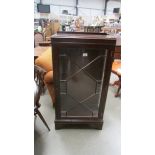 A 1930's mahogany display cabinet with astragal glazed door. 59 x 32 x 112 cm high.