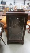 A 1930's mahogany display cabinet with astragal glazed door. 59 x 32 x 112 cm high.