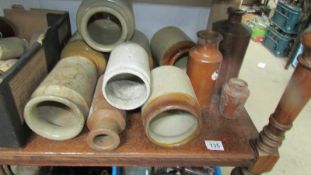 A box of stoneware bottles and jars.