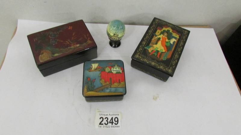 Three lacquered boxes including Russian example and a lacquered egg.