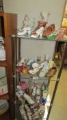 A good selection of pottery and porcelain shoe ornaments, 4 shelves.