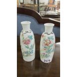 A pair of opaque hand painted glass vases (chip to rim on one).