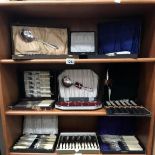 3 shelves of boxed/cased cutlery sets