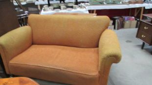 A 19th century? Victorian 2 seater drop arm sofa in ochre fabric.