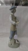 A Porcelarias Miguel Requienna Valencia porcelain figure of a hunter with a duck.