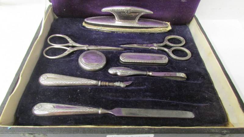 A cased silver plate manicure set (2 items missing and one odd item. - Image 2 of 2
