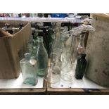 A lot of clean glass bottles many with maker's names
