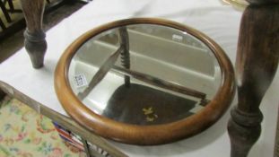 A circular bevel edged mirror.