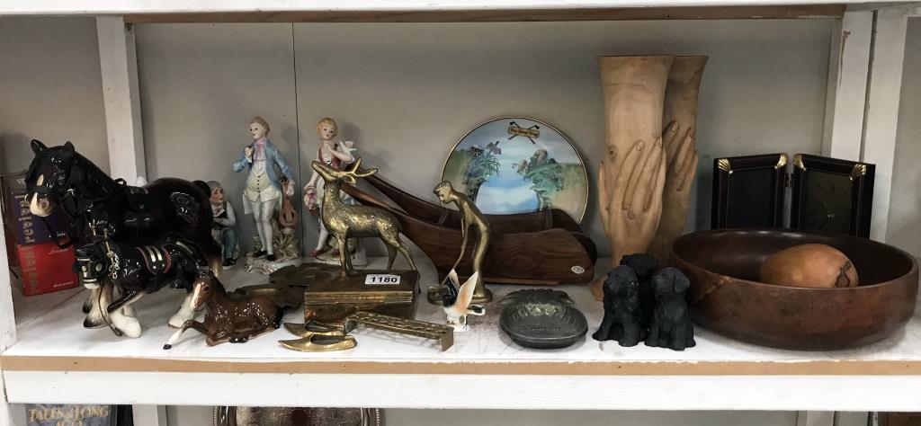 A large shelf of miscellaneous including brass,