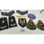 A selection of Ministry of Defence M.O.D guard service uniform badges etc.
