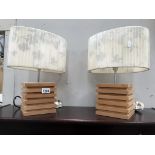 A pair of stylized wooden table lamps