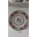 An early Chinese floral decorated plate, 23 cm diameter, chips to back rim.