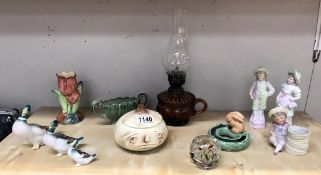 An amber glass finger oil lamp, bisque figures, Wade and Sylvac china, graduated ducks etc.