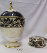 A Wedgwood 'Cornucopia' pattern lidded urn and a matching lidded pot.