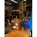 A brass companion set and a copper kettle.