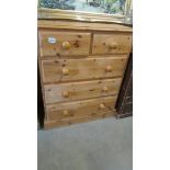 A 2 over 3 pine chest of drawers.