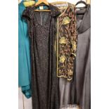 A collection of garments of varying designs and sizes including a heavily sequined jacket;