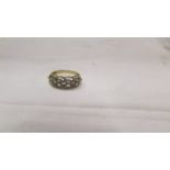 A 9ct gold ring set lilac coloured stones, size O half.