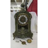 A Victorian Beulle mantel clock in good working order and in good condition with no lifting of