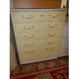 A cream 5 drawer chest.