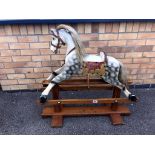 A 1920's wooden rocking horse with makers label of 'Leeway'.