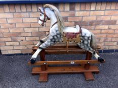 A 1920's wooden rocking horse with makers label of 'Leeway'.