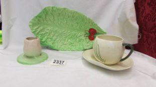 A Carlton ware cup and saucer and two other pieces of Carlton ware.