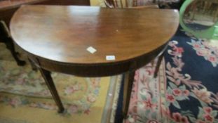 A D shaped mahogany table.