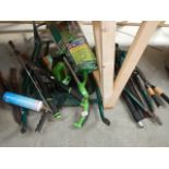 A quantity of electric garden tools and a flat pack wheel barrow.